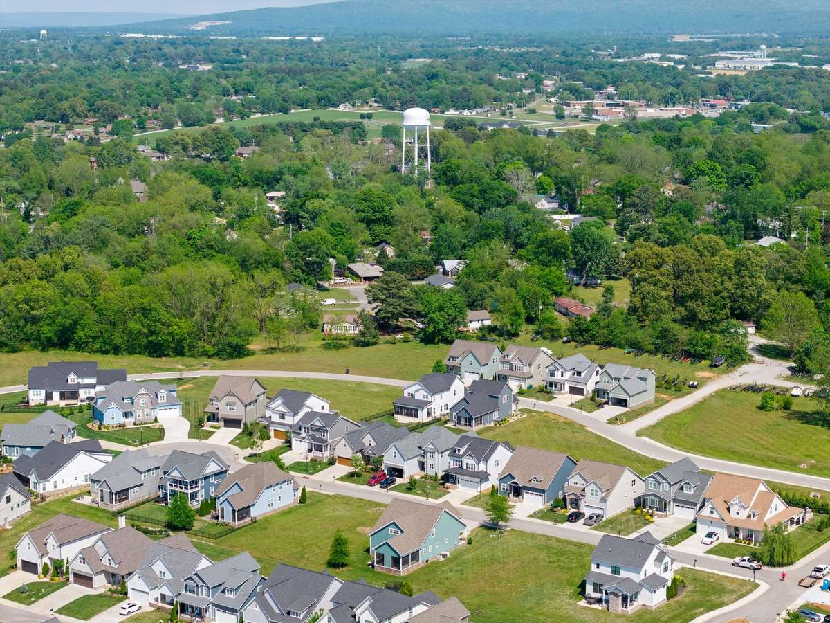 Expansive views of the neighborhood with rolling green space and nearby waterfront access.