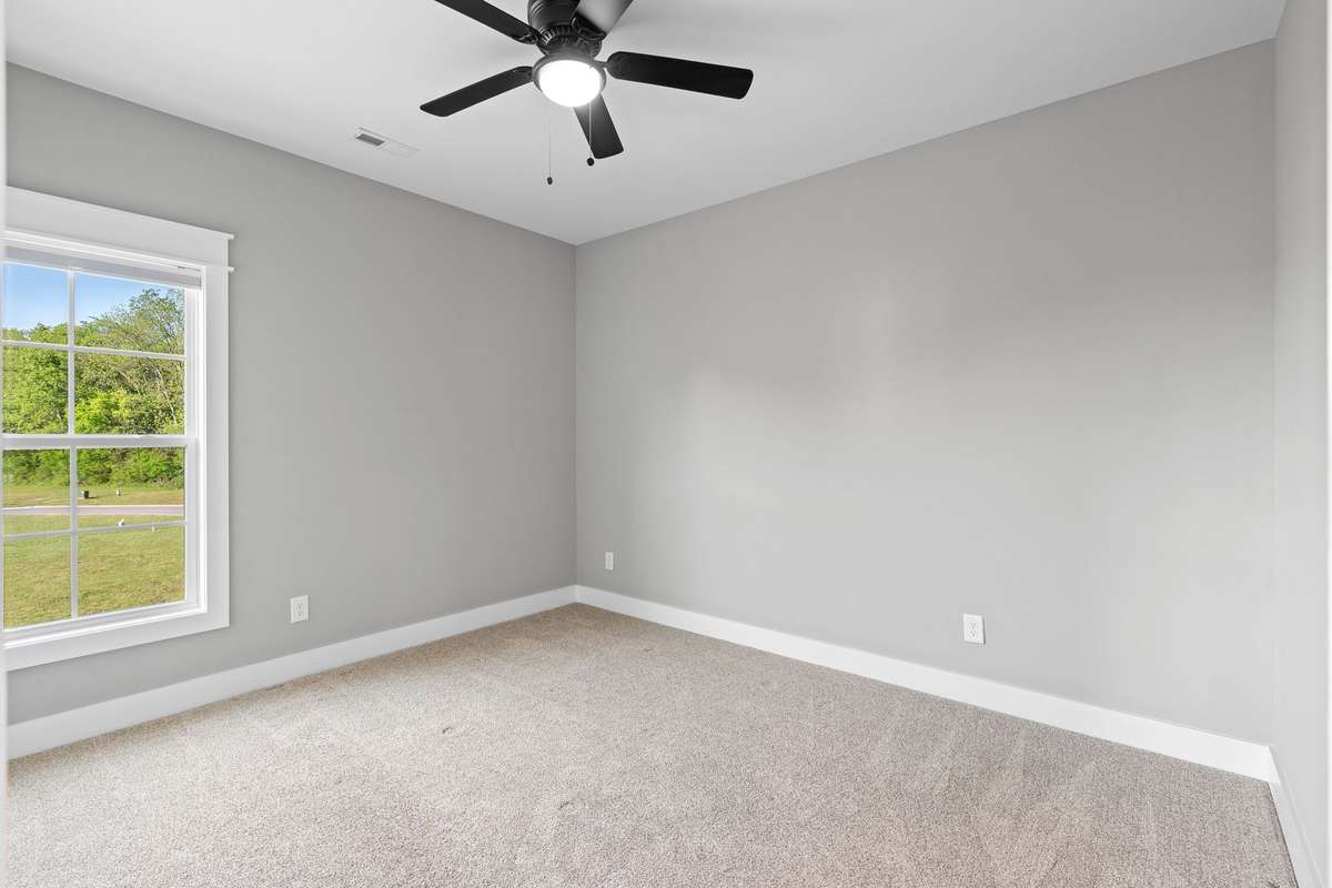 Additional bedroom with neutral finishes and ample closet space.