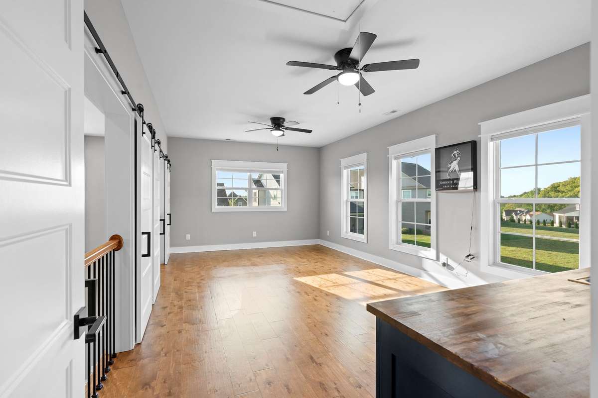 Huge bonus room with abundant natural light—ideal for game nights, media room, or entertaining.