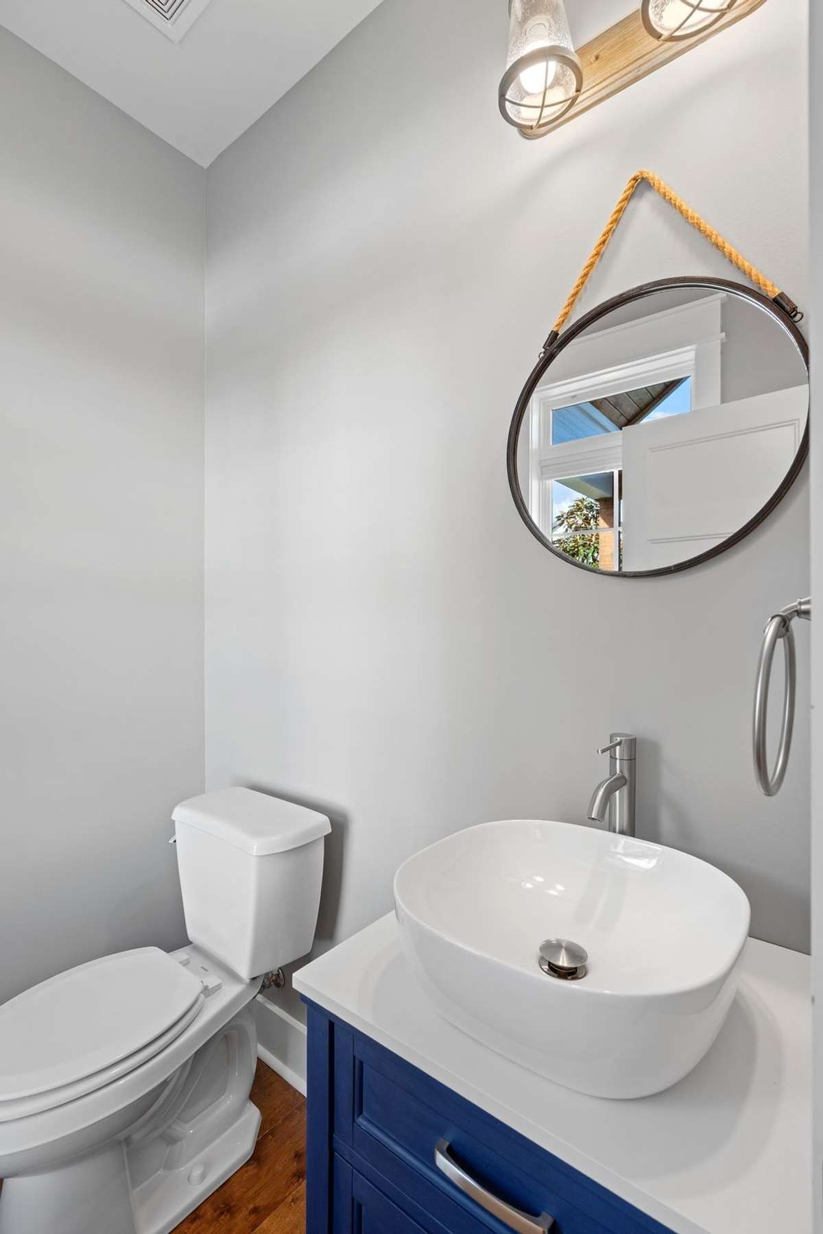 Designer half bath with stylish vanity and modern accents.
