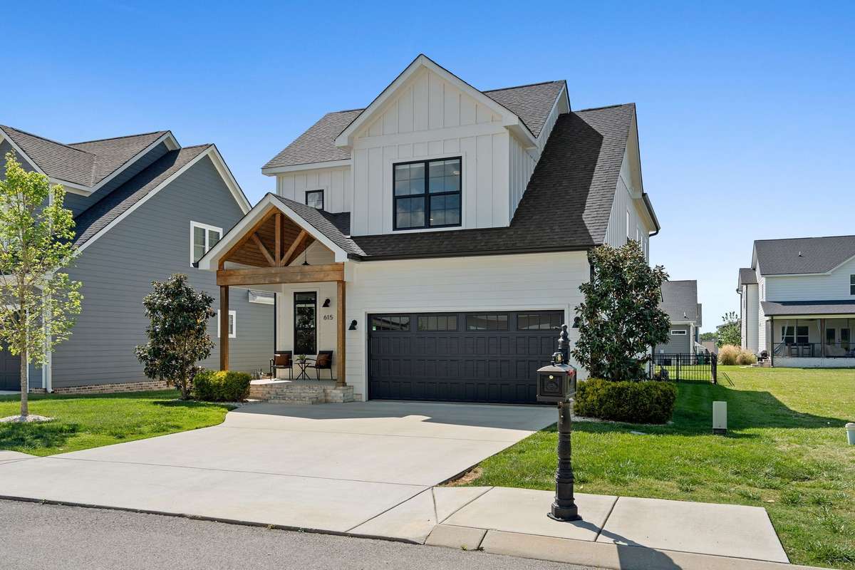 Spacious driveway and two-car garage with clean architectural lines and modern finishes.