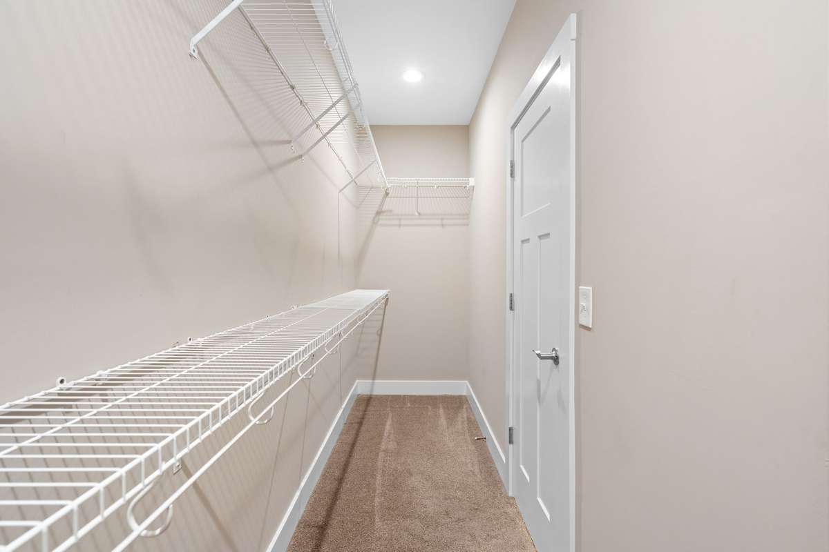 Generous walk-in closet with plenty of shelving and hanging space for organization.