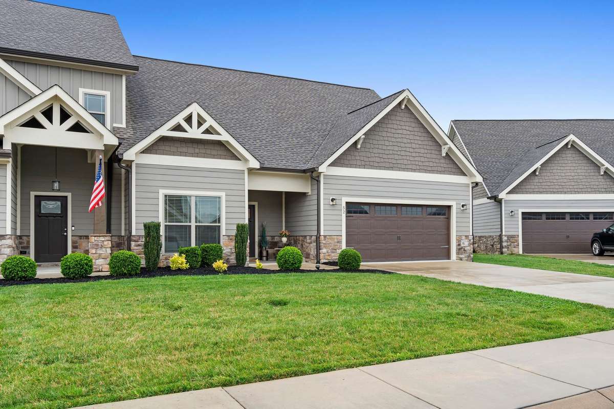 Beautiful craftsman-style architecture with manicured lawn and inviting front entry.