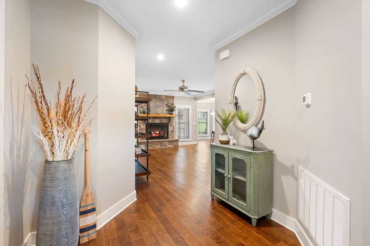 Spacious foyer with hardwood floors leading into the open living areas.