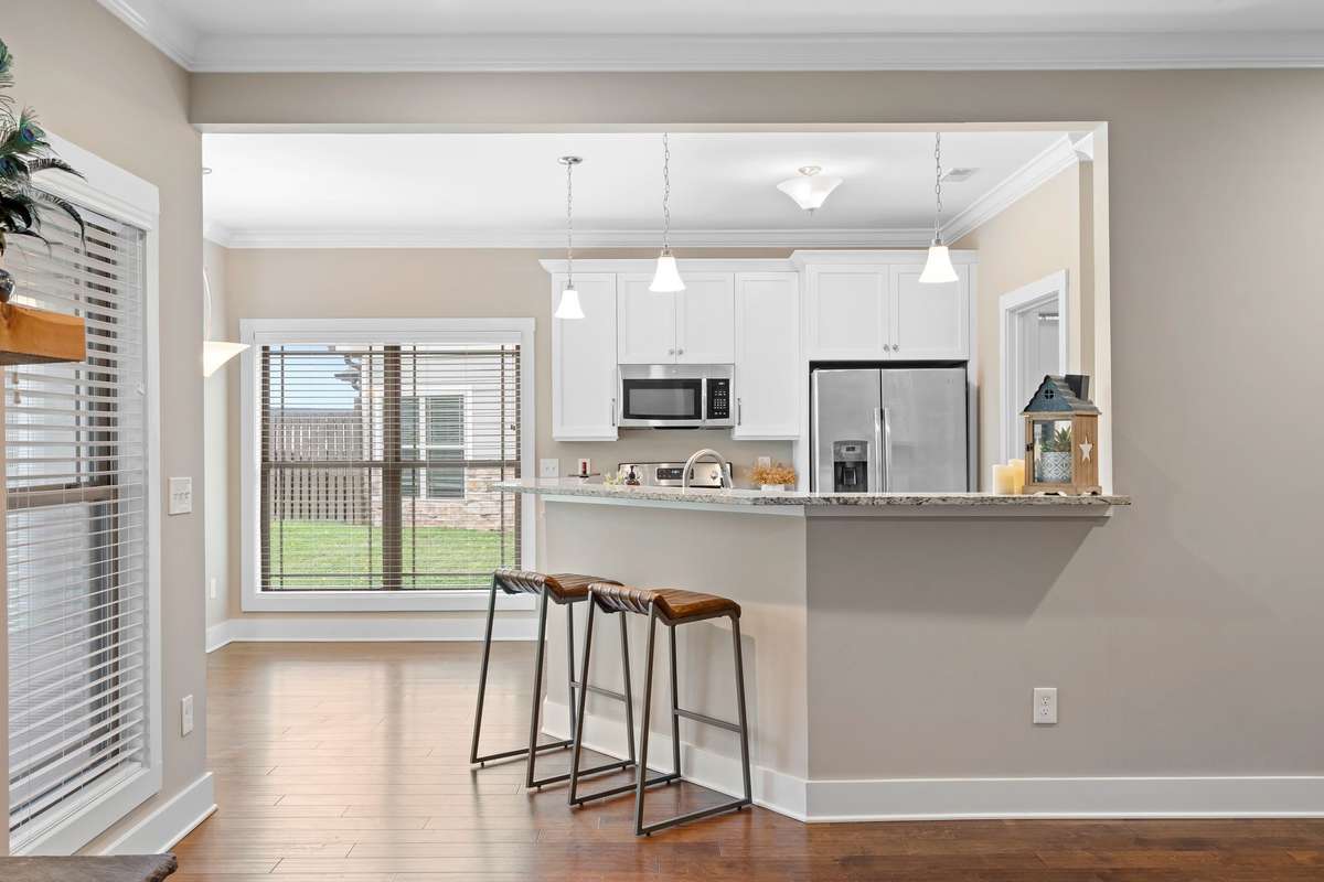 Open living space with direct access to the kitchen and breakfast bar seating.