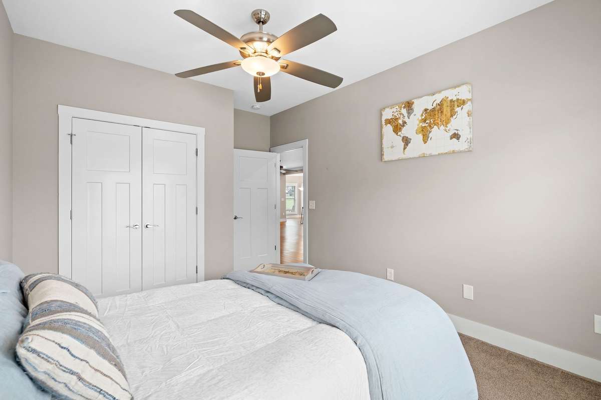 Guest bedroom view with double closet and easy access to main living areas.