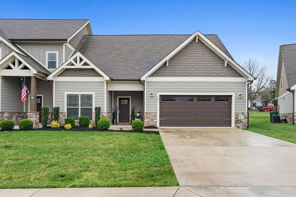 Charming townhouse exterior with welcoming curb appeal in desirable Twin Creeks Village.