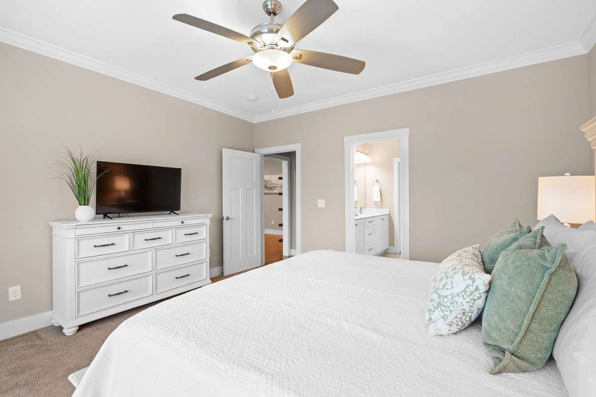 Spacious primary suite with neutral tones and private bath access.