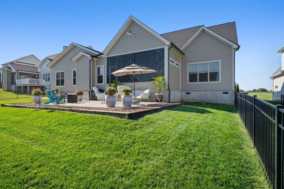 Private backyard with spacious patio, lush landscaping, and plenty of room for entertaining or relaxing.