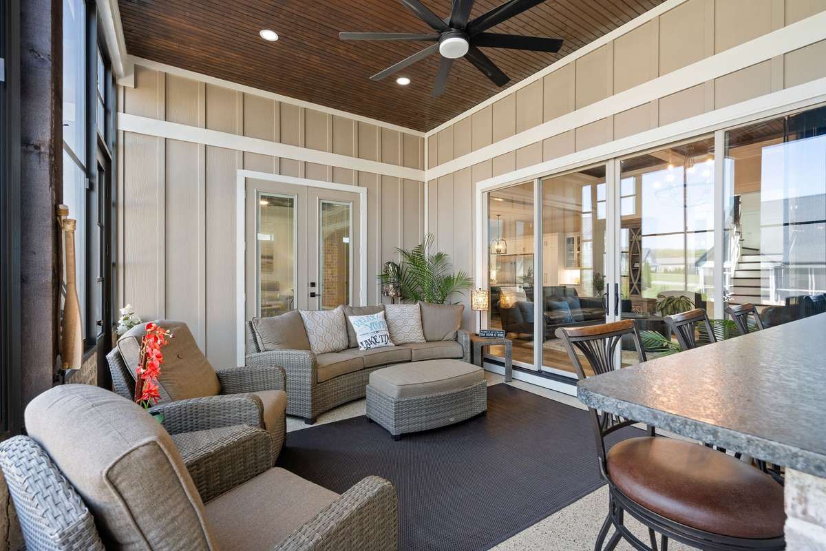 Comfortable and inviting screened porch living area—perfect for relaxing evenings overlooking the backyard.