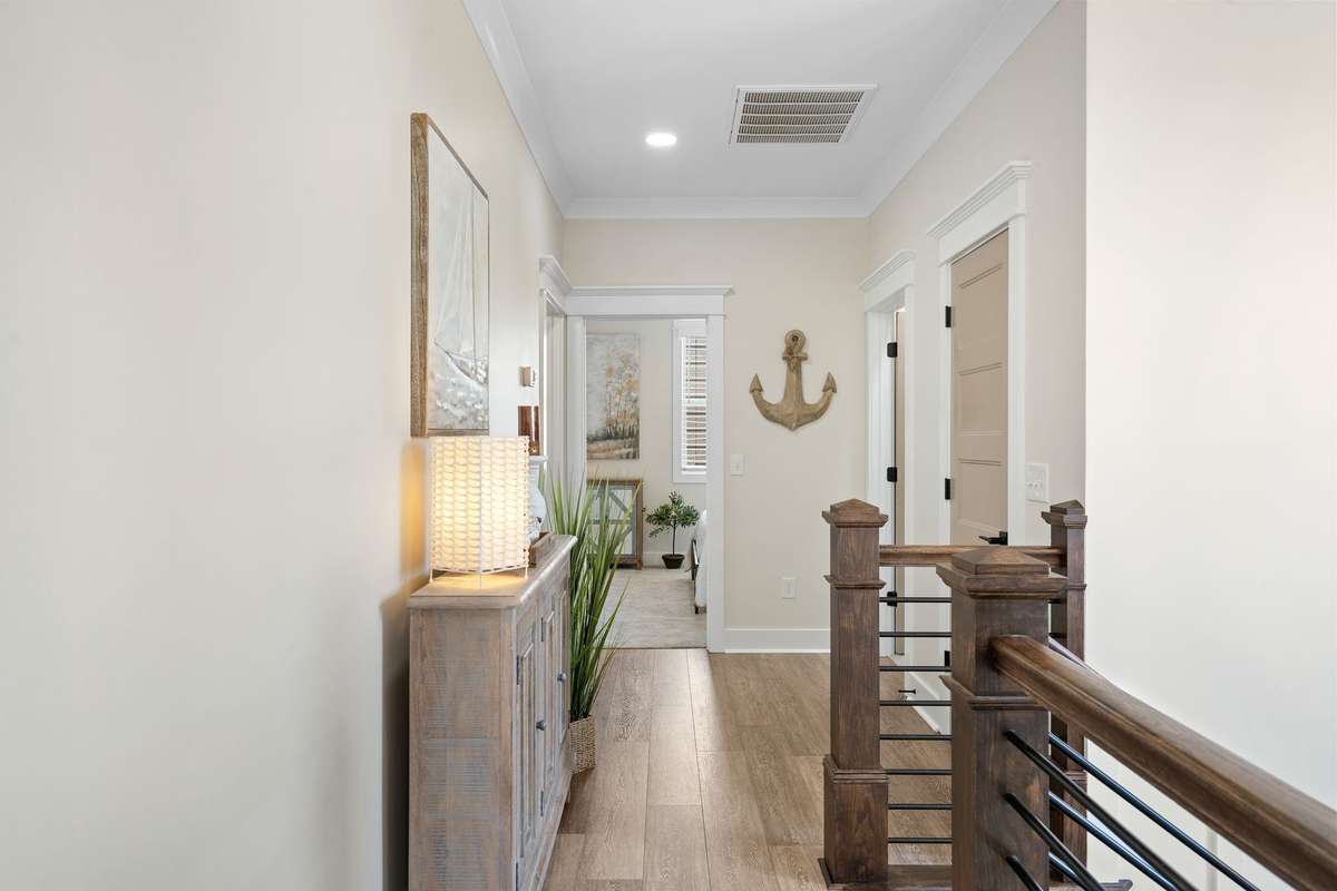 Open hallway with custom railing and seamless flow between living spaces.