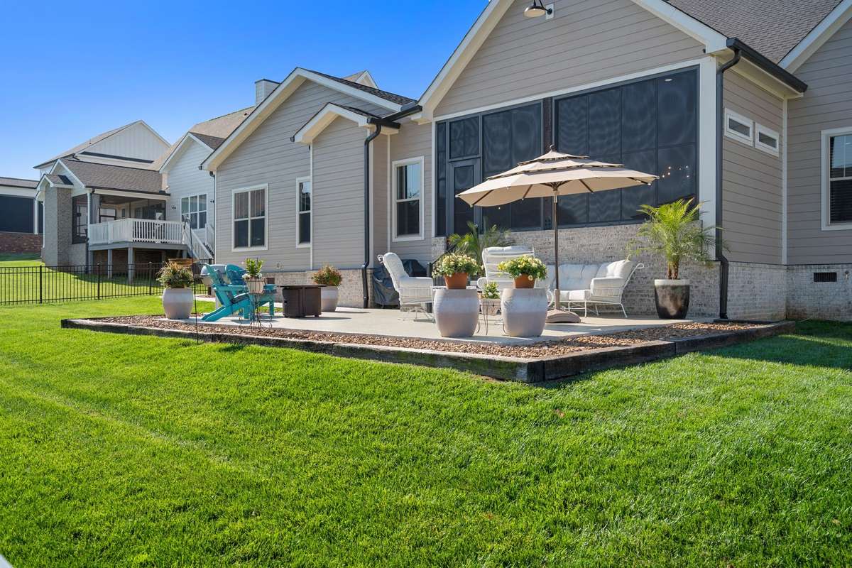 Thoughtfully designed outdoor living space with multiple seating areas and scenic neighborhood views.