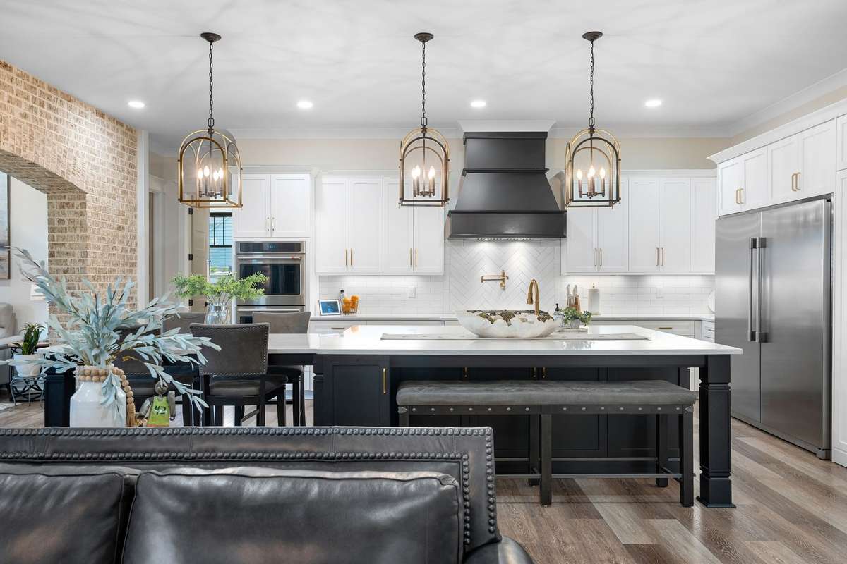 Spacious chef’s kitchen with oversized island, quartz countertops, custom cabinetry, and designer lighting.