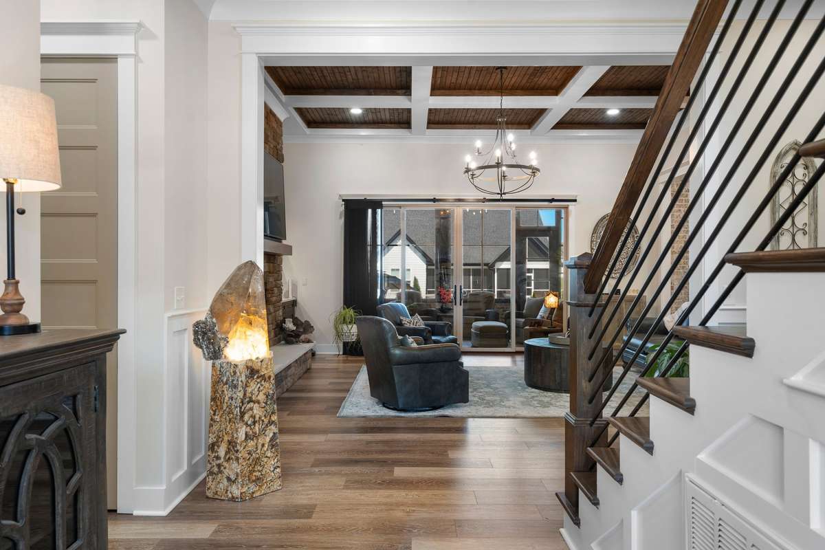 Welcoming entryway featuring upscale finishes, warm tones, and an open view into the main living space.