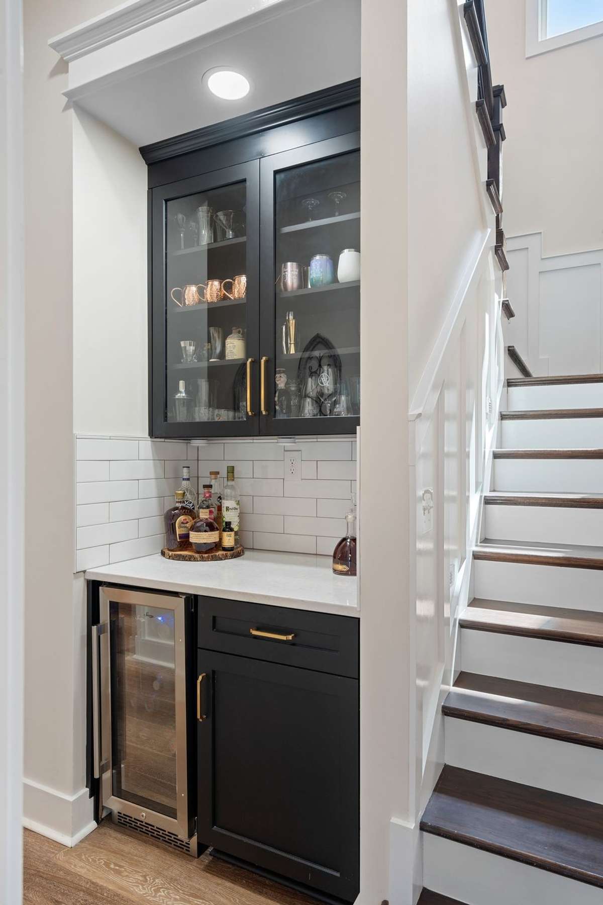 Custom wet bar with beverage fridge and cabinetry—ideal for entertaining guests.