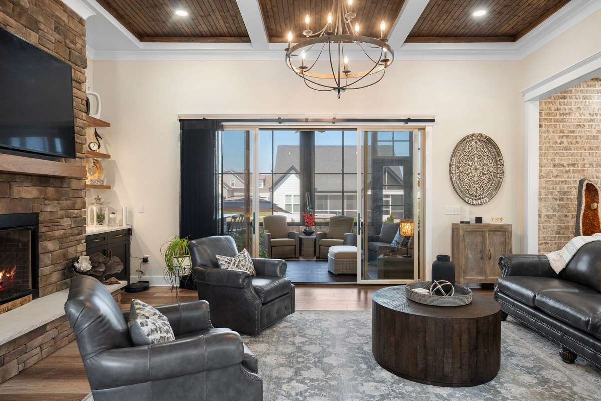 Indoor-outdoor living at its finest—sliding doors open wide to extend the living space onto the screened porch.