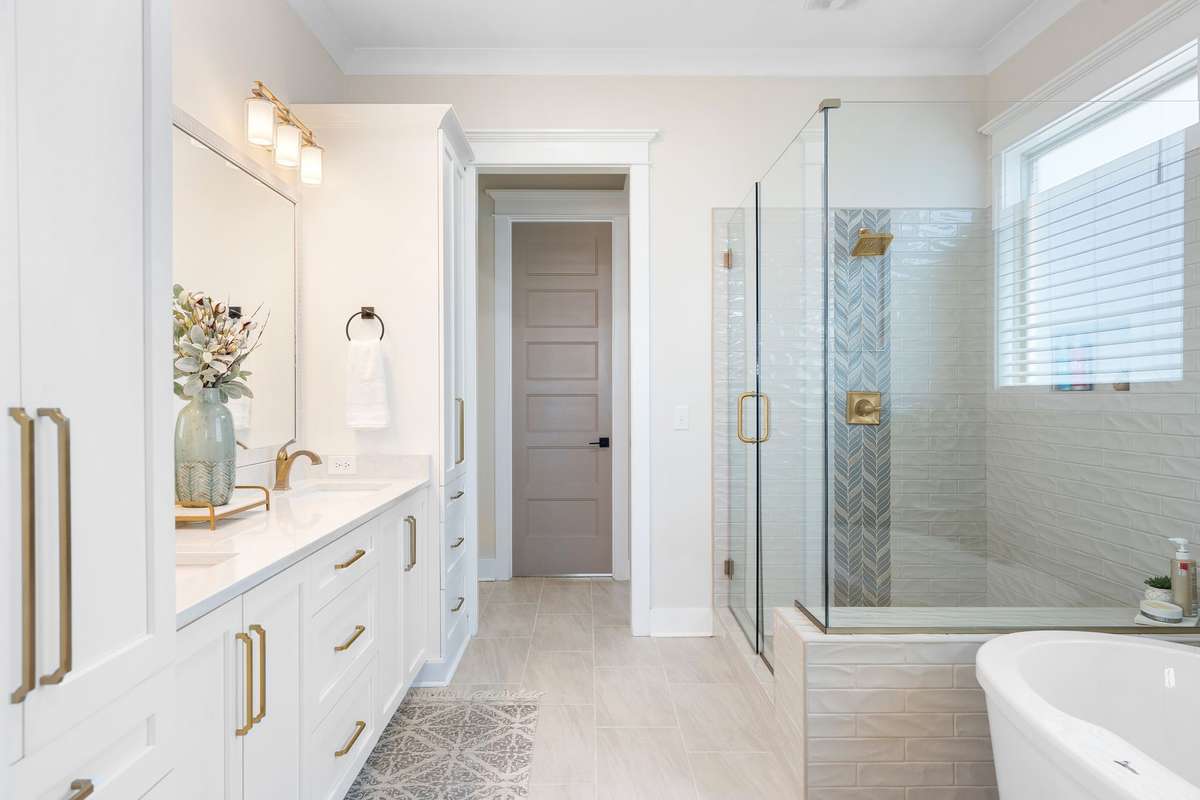 Luxurious primary bath with oversized tiled shower, glass enclosure, and upscale finishes.