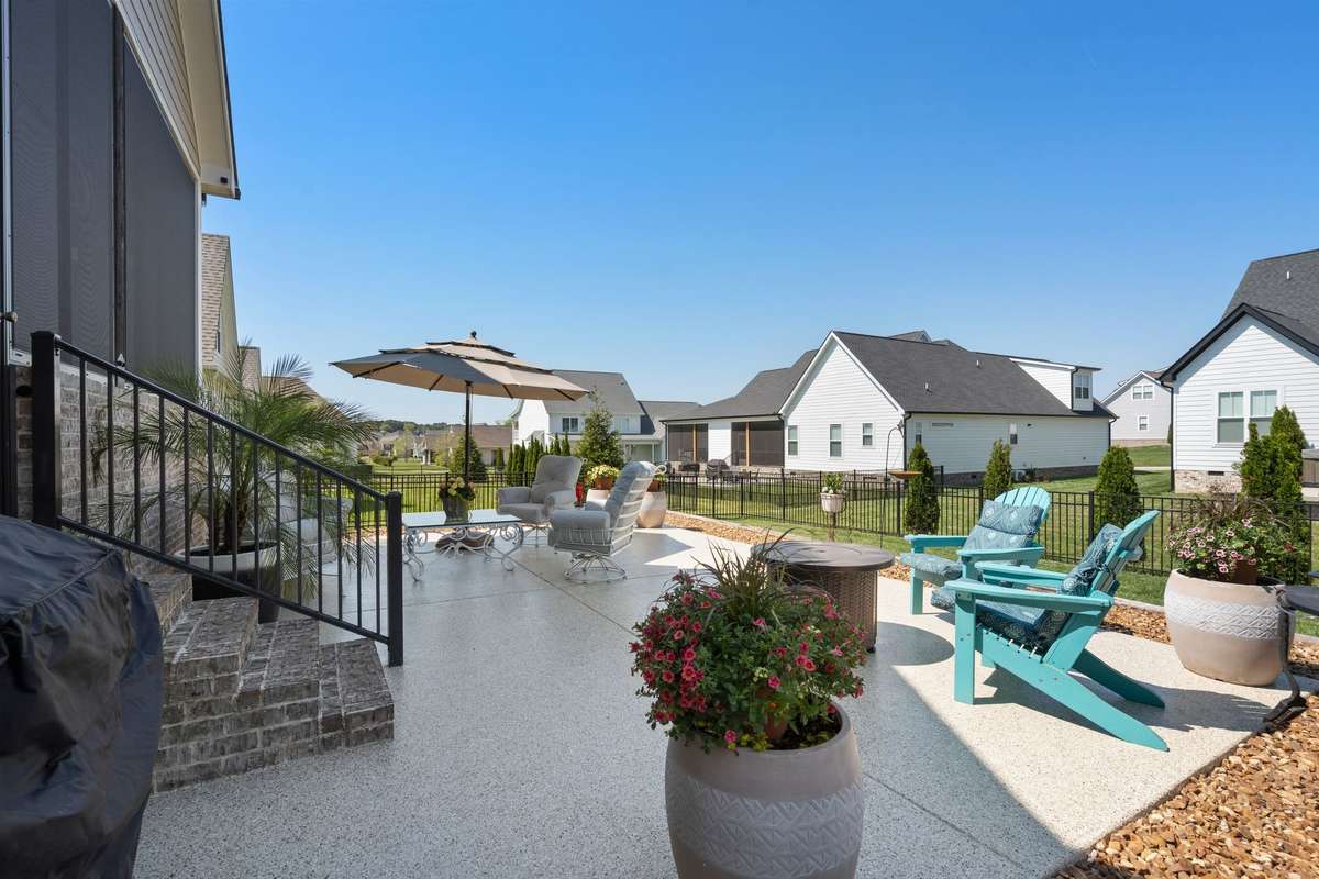 Enjoy peaceful backyard views from this beautifully landscaped patio in the heart of Twin Creeks Village.