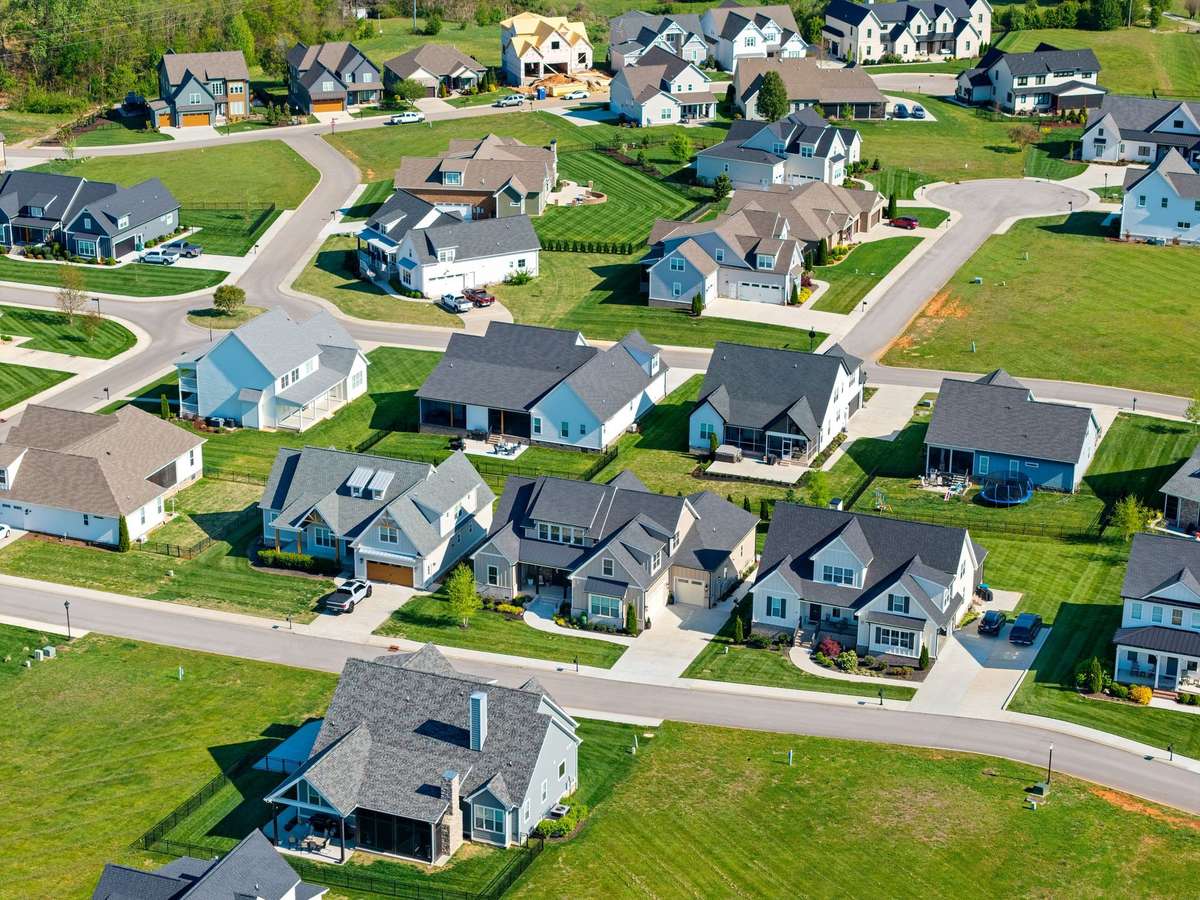 Wide aerial perspective highlighting spacious homesites, sidewalks, and the thoughtfully designed neighborhood.