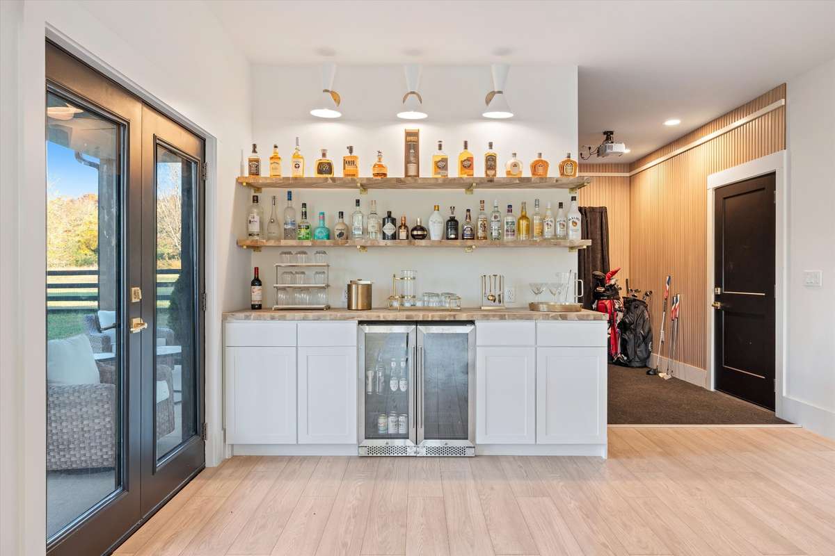 Downstairs rec room with dry bar and beverage fridge