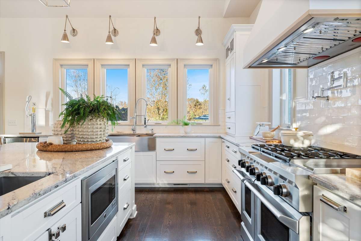 Six burner gas range with griddle, heat lamps, and pot filler
