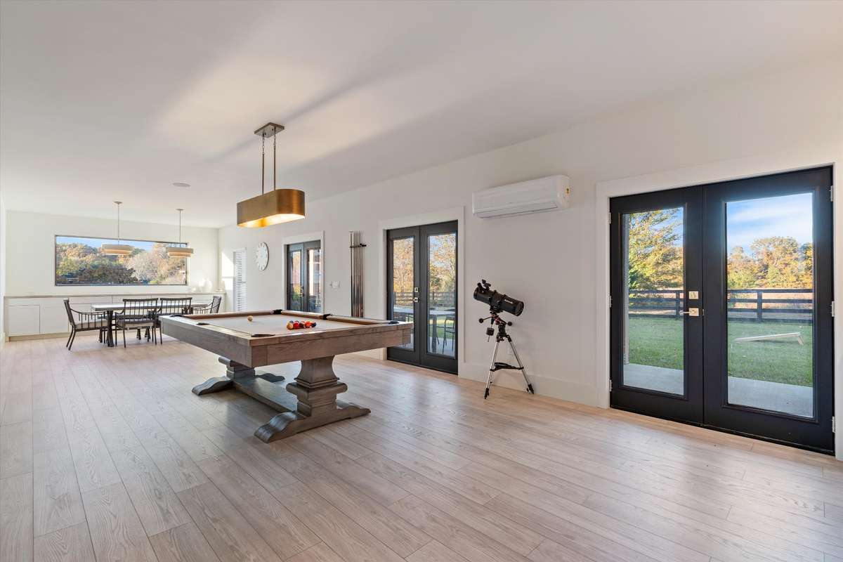 View of entire rec room with doors exiting to back porch area