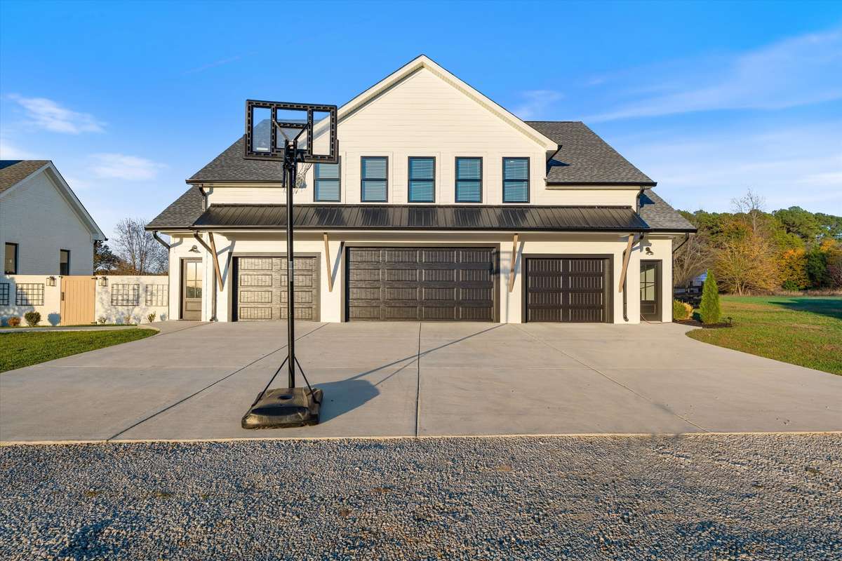 Front of Multipurpose entertainment house. Oversized middle bay garage door.