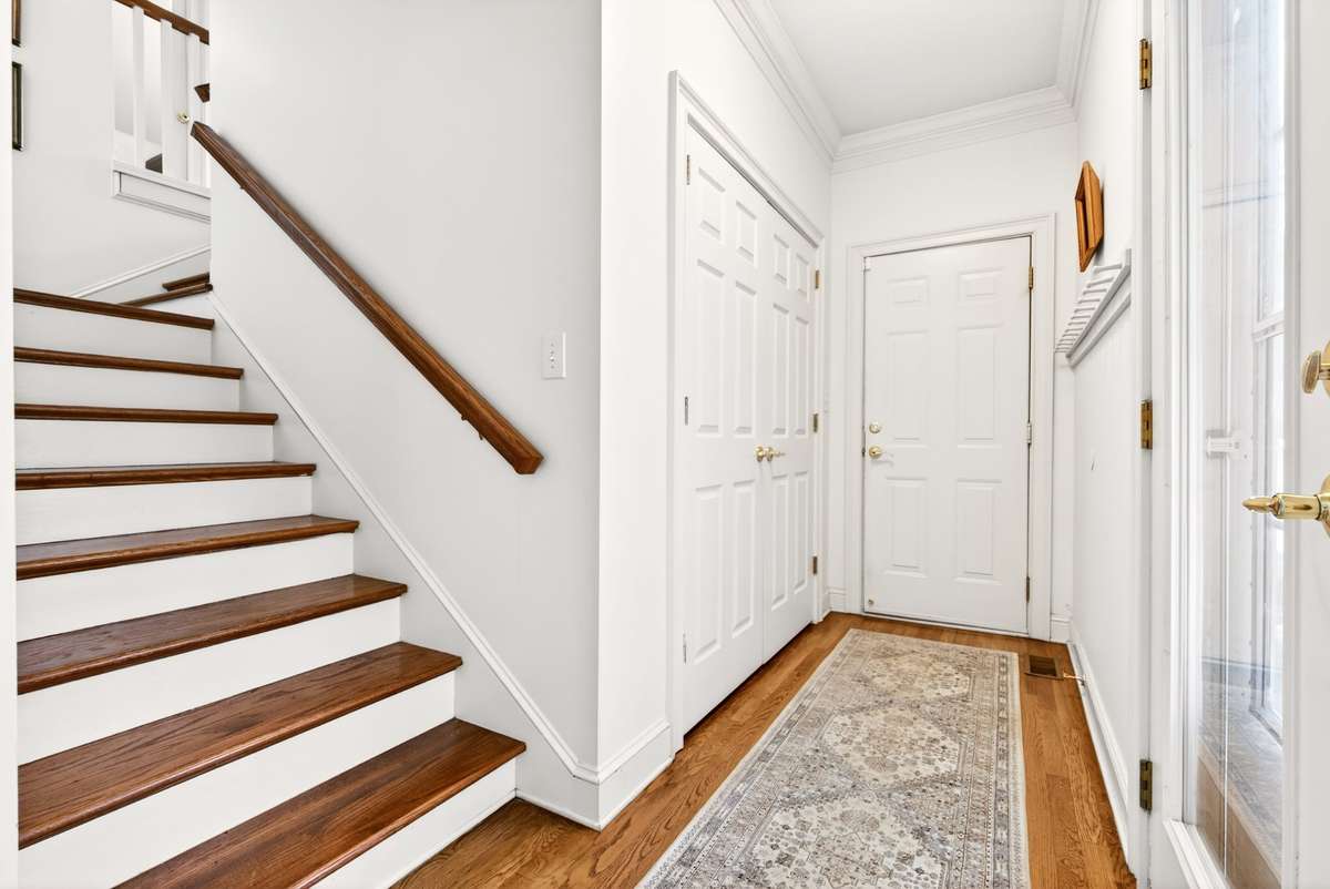 Mudroom with new peg wall, large coat closet, and access to garage and backyard.