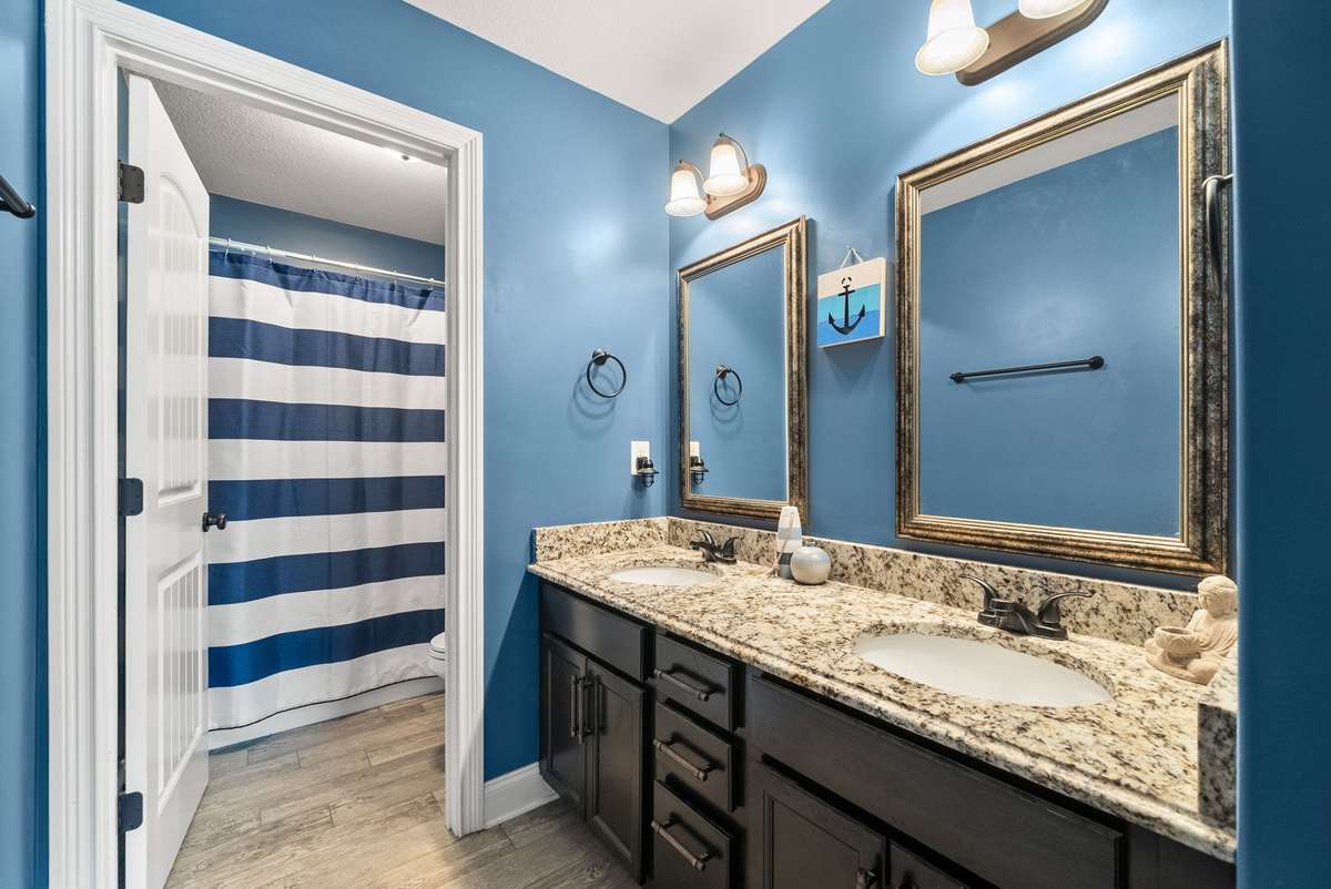 Upstairs spare bath with double vanities, LVP floors and linen closet