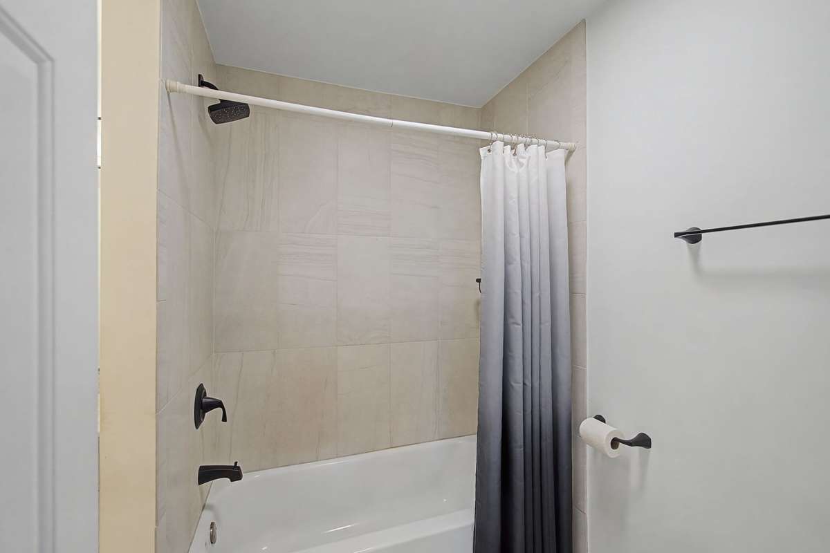 The entire bathroom has been updated with beautiful, large tiles in the shower surround and on the floor.
