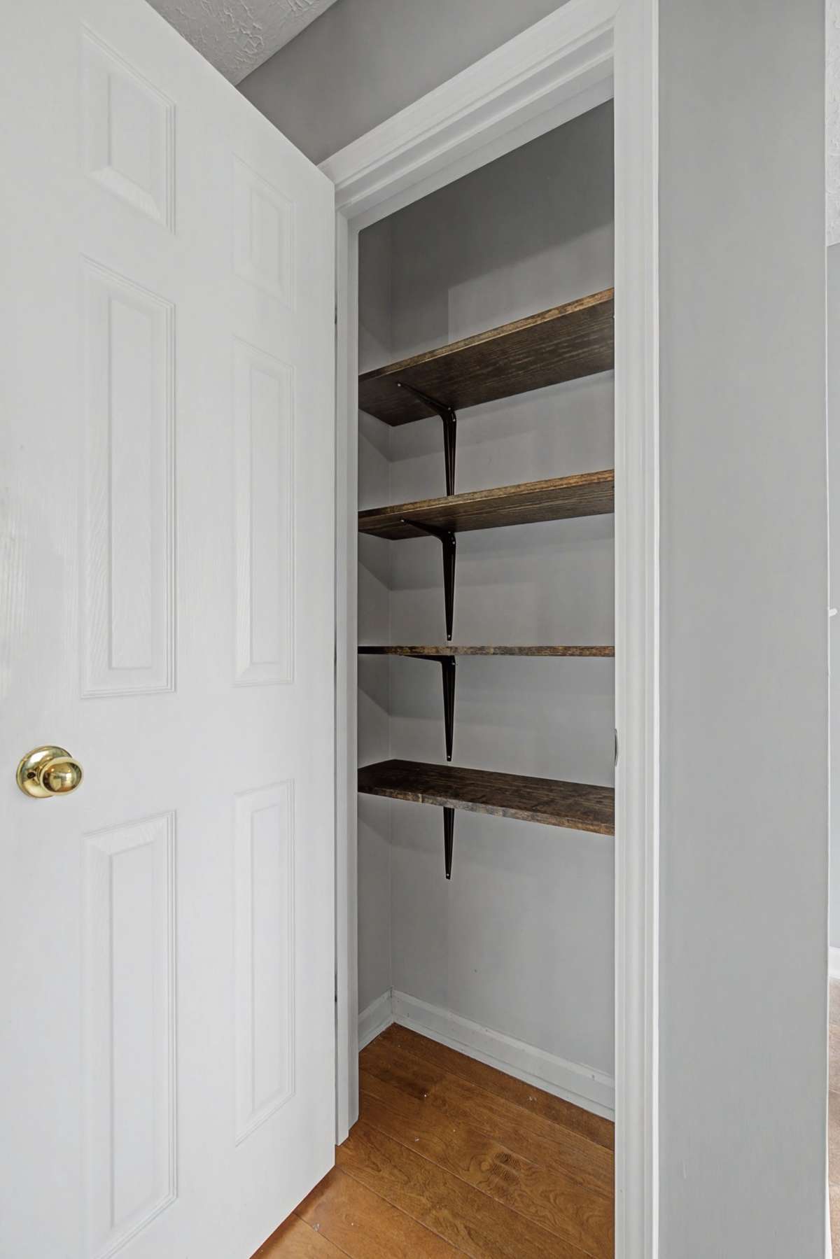 NEW WOOD SHELVING was installed in the pantry that is located next to the half bathroom and right before you enter the kitchen.