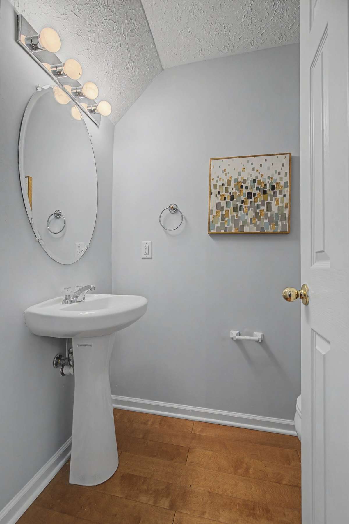 The main level half bathroom is located right around the corner from the fireplace.