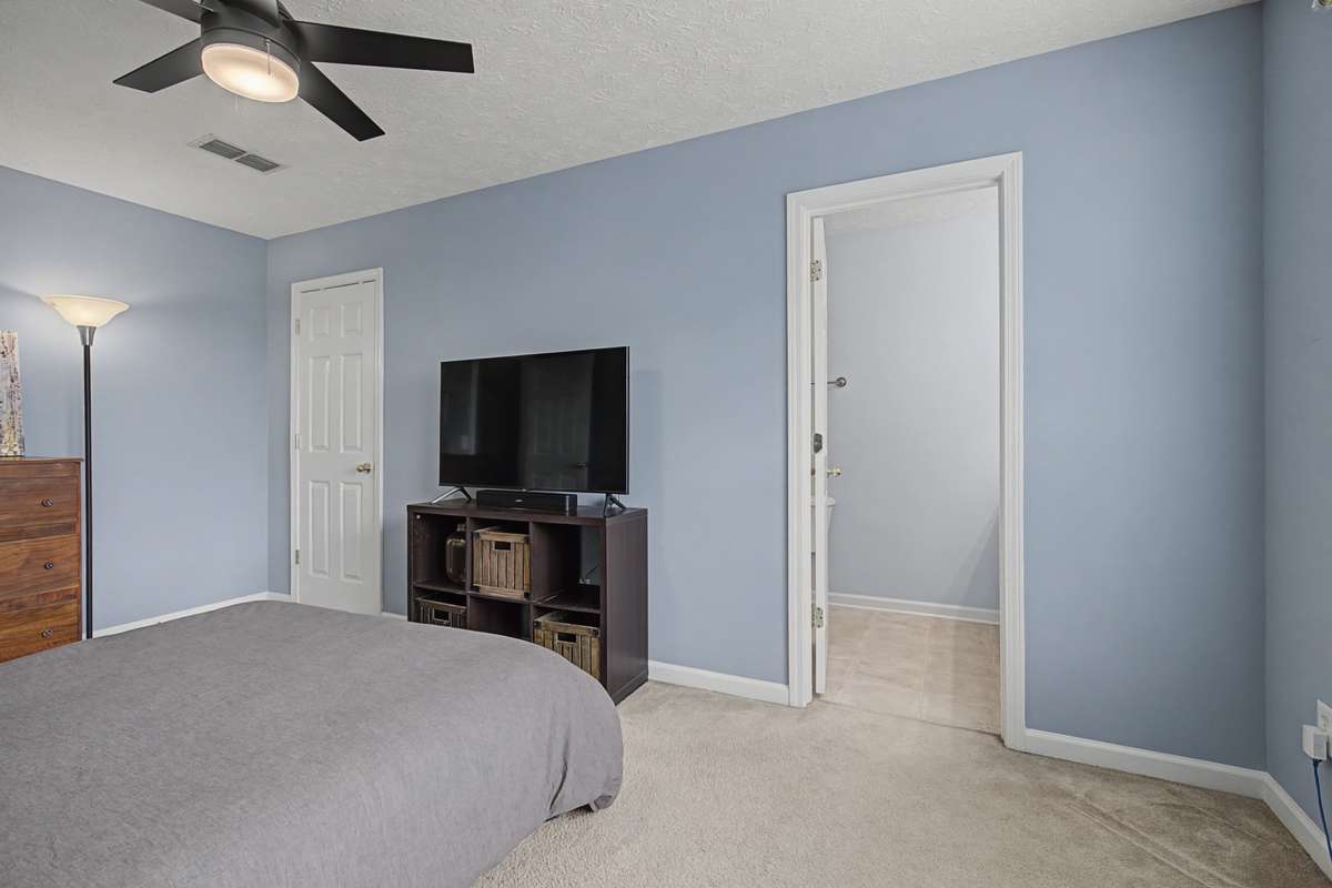 The door on the left is to the walk-in closet and the open doorway is to the primary bathroom.