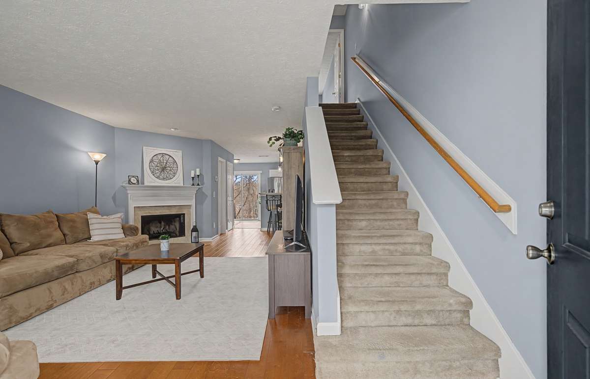 The main level is CARPET-FREE and features a centrally located WOODBURNING FIREPLACE.