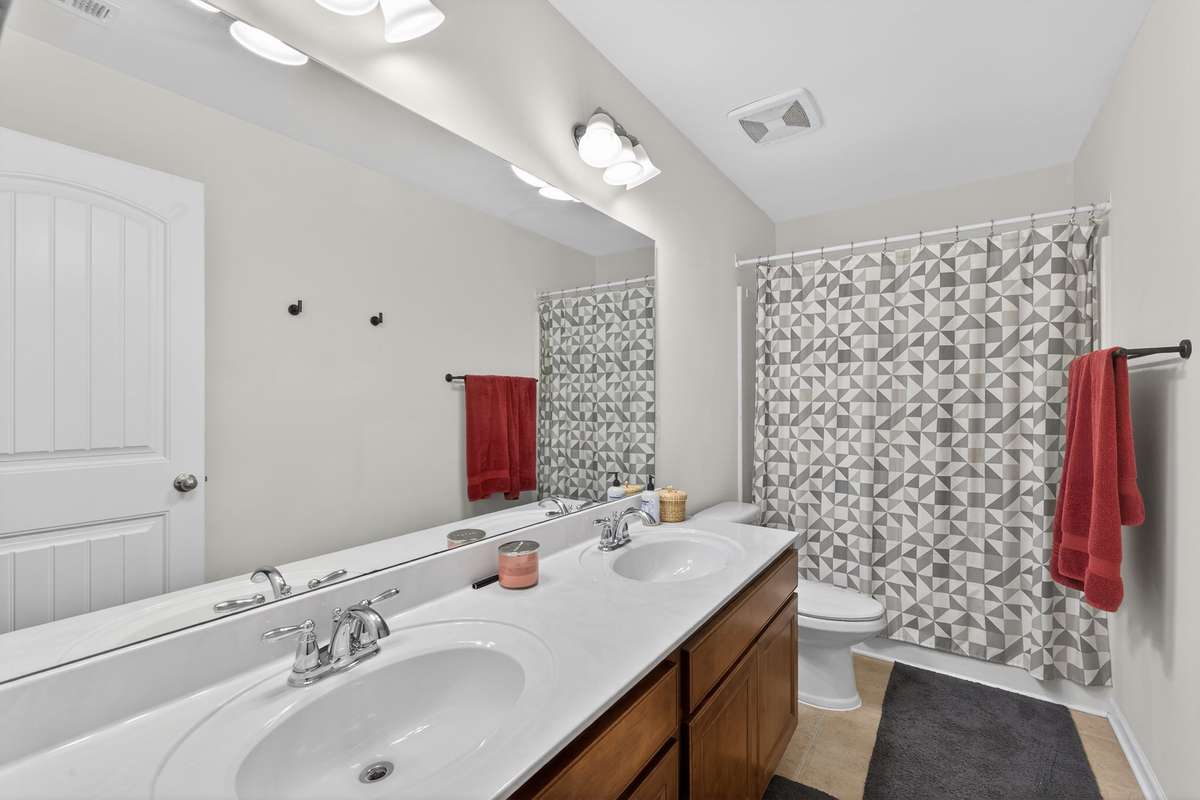 Full bath on 2nd floor with double vanities and combo shower/tub