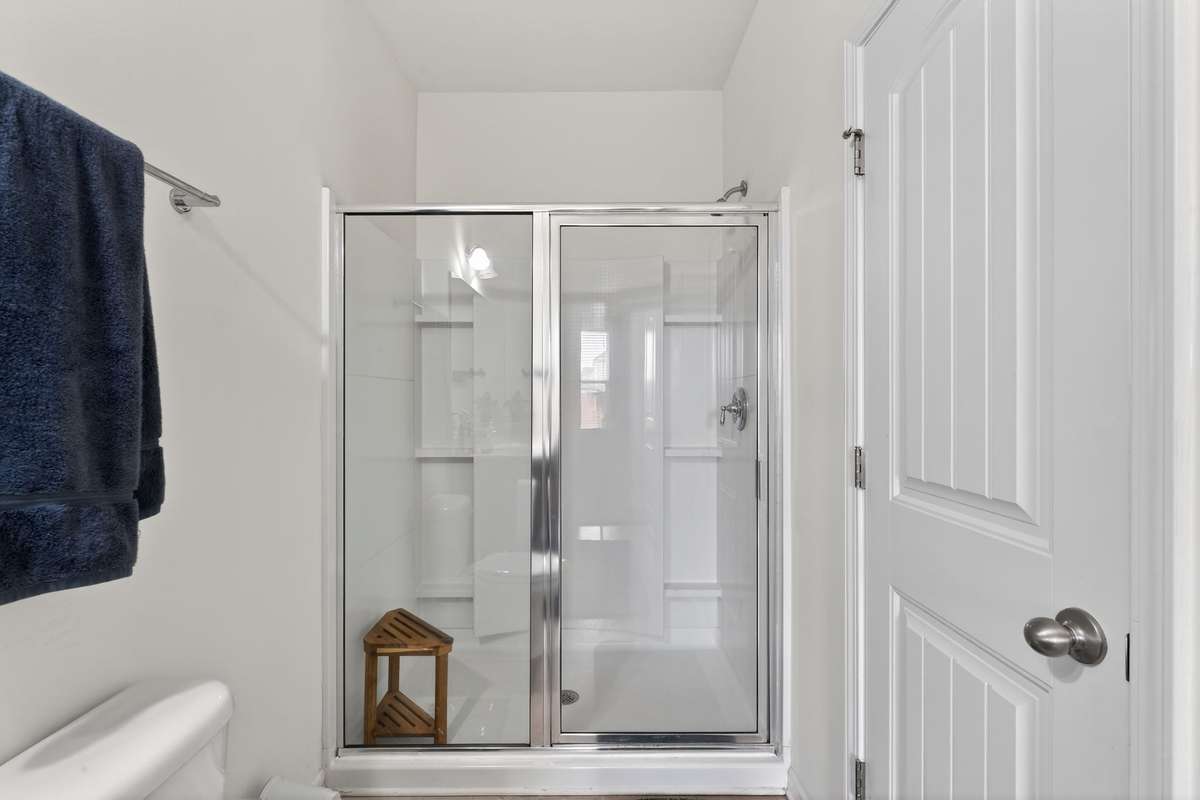Spacious shower and convenient linen closet