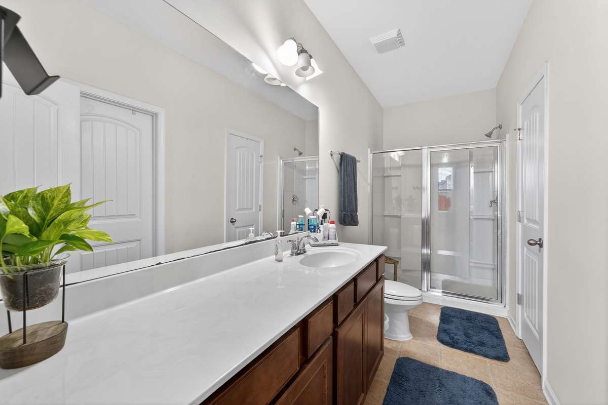 Primary bath with long vanity. It is already pre-plumbed for 2nd sink and pre-wired for 2nd overhead light.
Walk-in closet just inside doorway