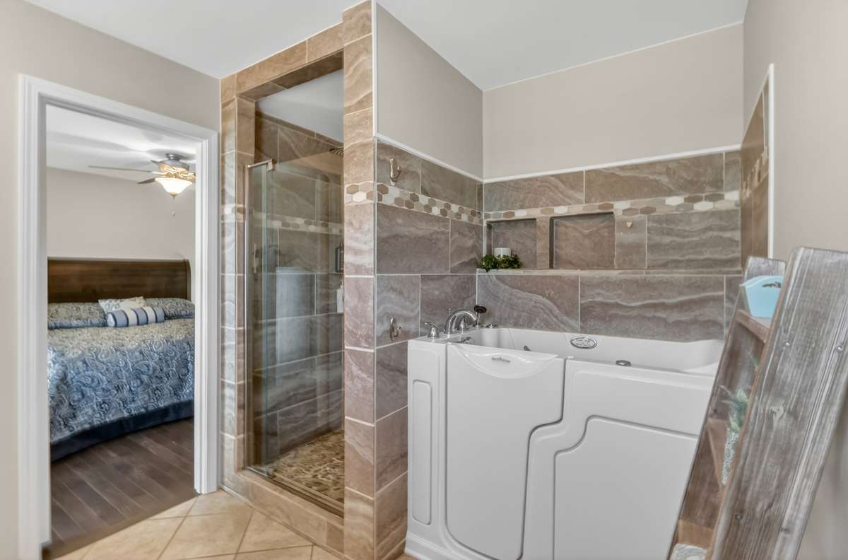 Beautifully tiled shower and walk-in tub