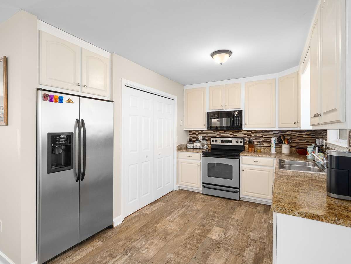 Freshly painted kitchen cabinets with stainless steel appliances