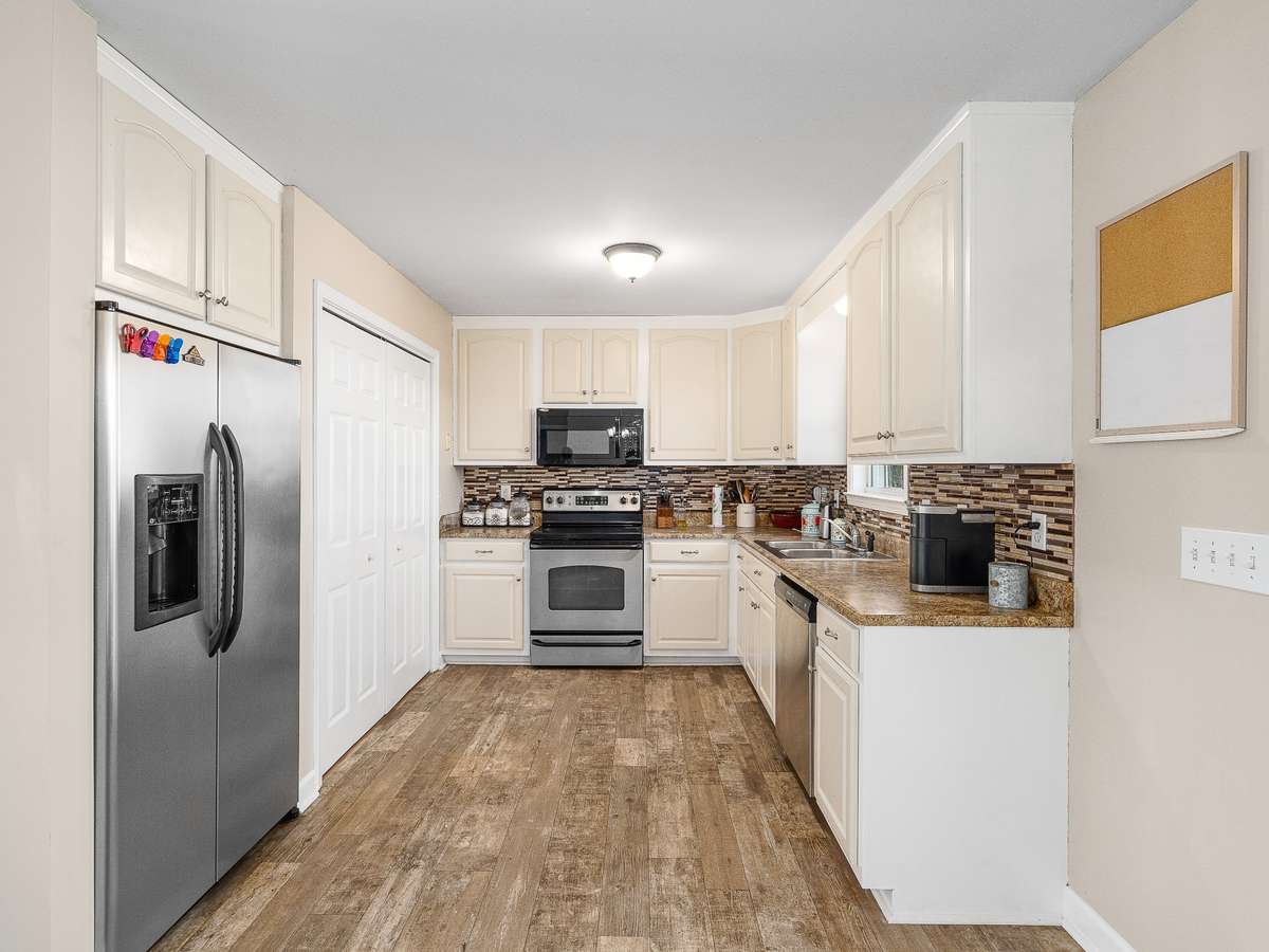 Freshly painted kitchen cabinets with stainless steel appliances