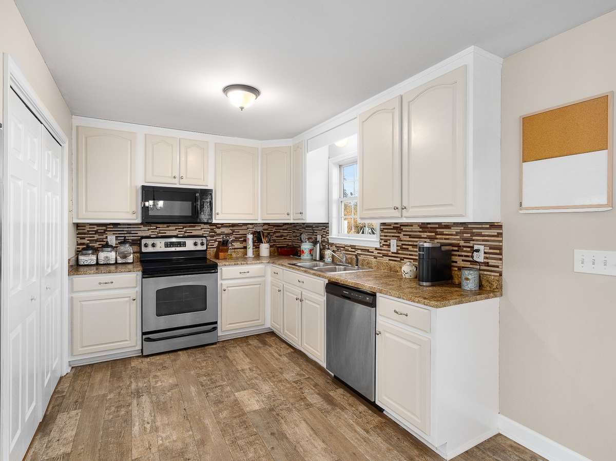 Freshly painted kitchen cabinets with stainless steel appliances