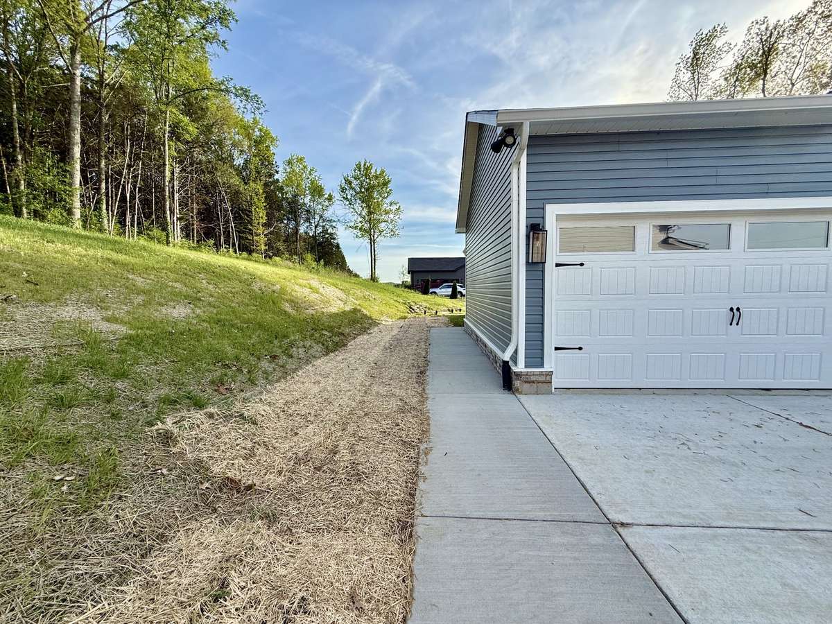 Additional concrete was added for sidewalk to rear of home along with widening driveway turnaround
