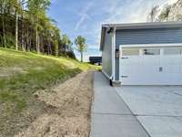 Additional concrete was added for sidewalk to rear of home along with widening driveway turnaround