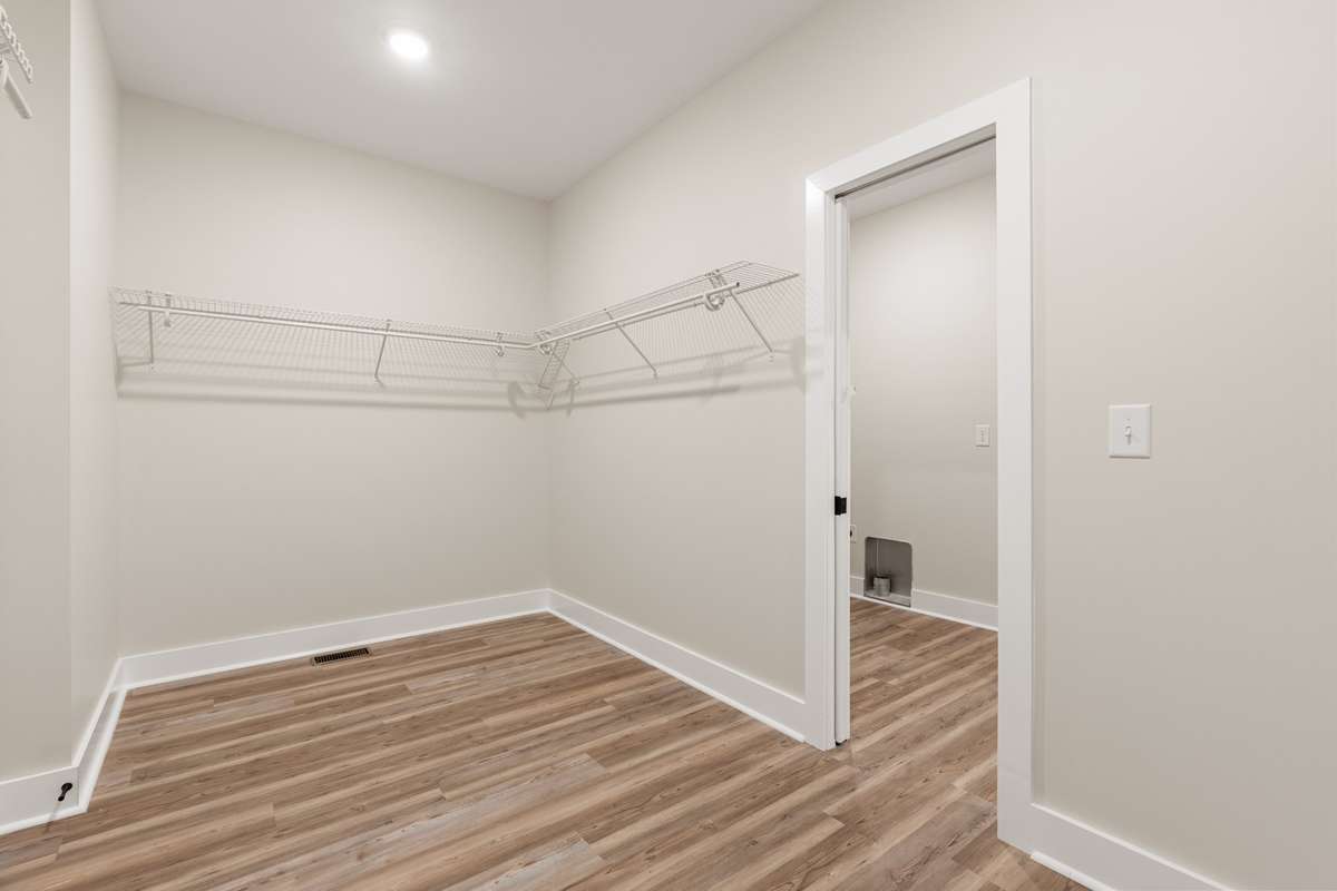 Primary Bedroom Closet with access to laundry room