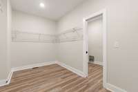 Primary Bedroom Closet with access to laundry room