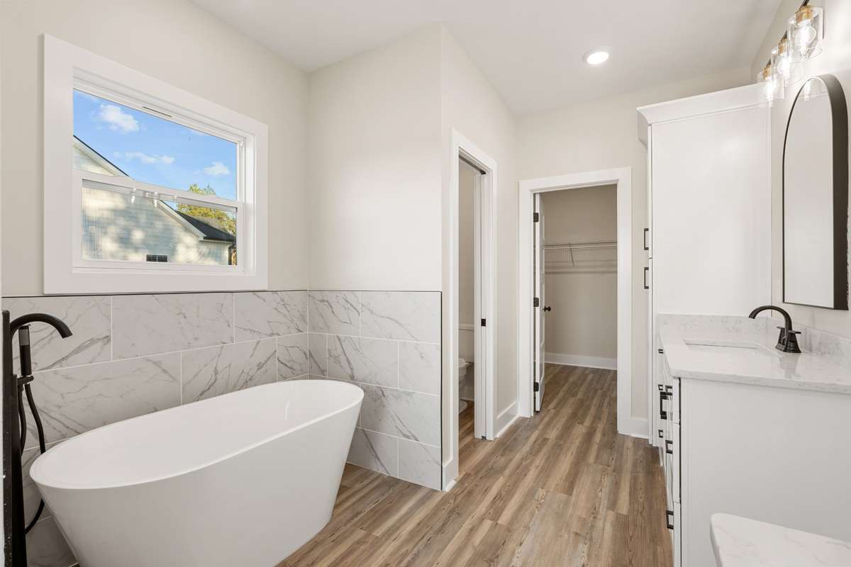 Primary Bathroom with access to water closet and bedroom closet