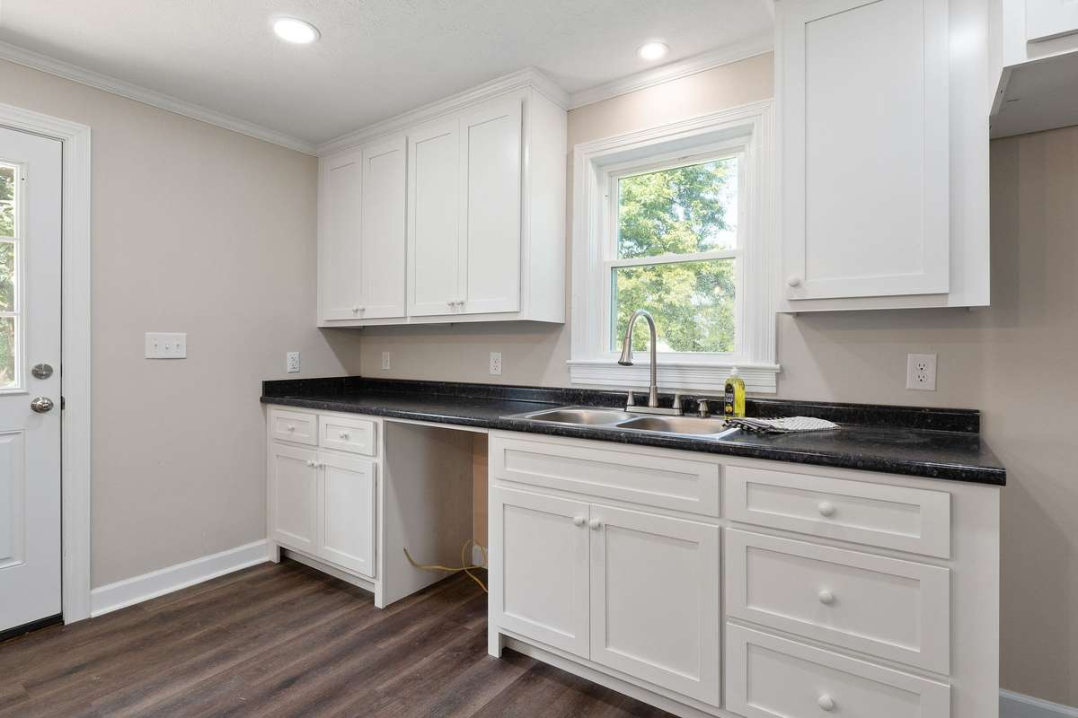 The kitchen features recessed lighting.