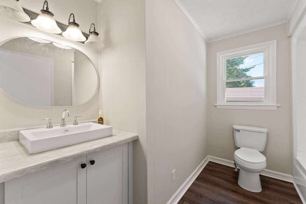 The bathroom has a shower/tub combo.