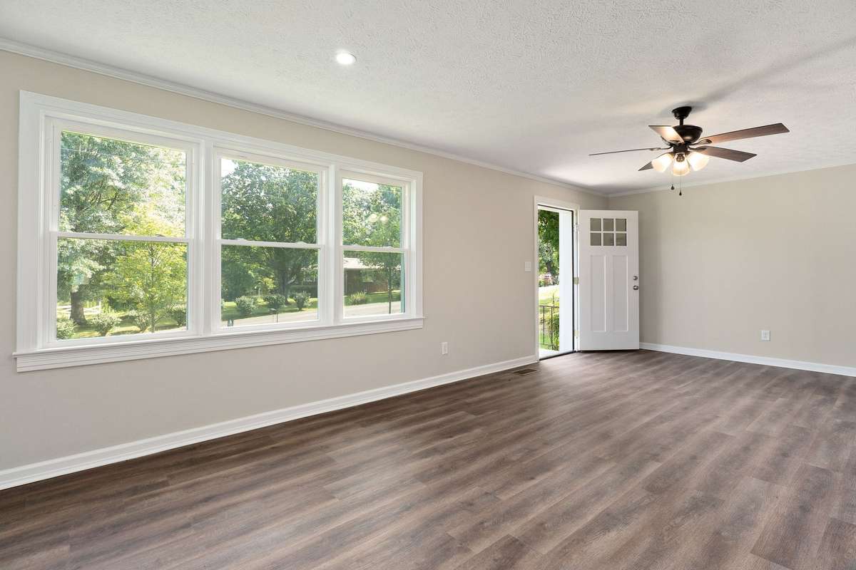 The living room features a large window that provides loads of natural light.