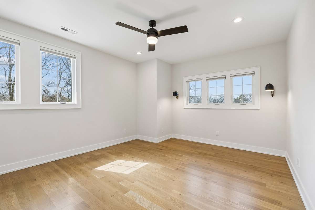 4th bedroom features functional reading lighting, perfect for a queen sized bed and nightstands or comfortably fits a king bed if desired. Fit with generous walk-in closet and beautiful en suite bathroom.